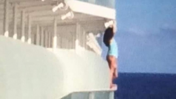 
Woman banned from cruise after 'dangerously posing' on ship for selfie
