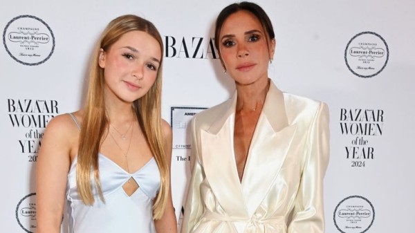 Victoria Beckham presented with a Harper's Bazaar women of the year prize from daughter Harper Victoria Beckham presented with a Harper's Bazaar women of the year prize from daughter Harper