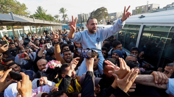 Four female soldiers reunite with families in Israel - as freed Palestinian prisoners carried by huge crowds in West Bank