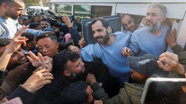 Four female soldiers reunite with families in Israel - as freed Palestinian prisoners carried by huge crowds in West Bank