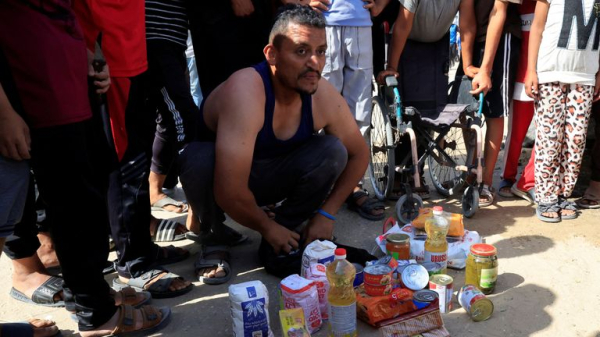 Palestinians flock to Gaza aid centres despite concerns - as lawyers call for sanctions on Israel