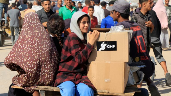 Palestinians flock to Gaza aid centres despite concerns - as lawyers call for sanctions on Israel