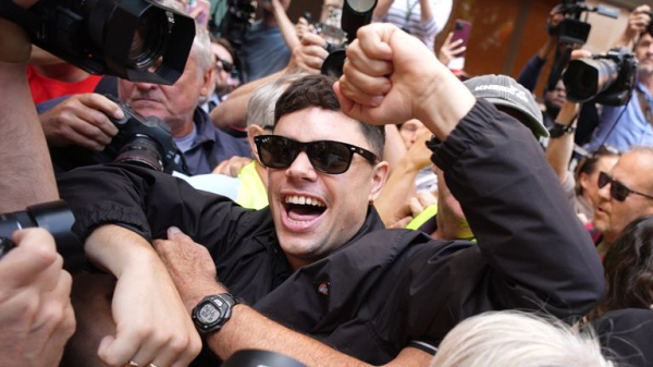 Kneecap rapper appears in court on terror charge - as protesters gather outside